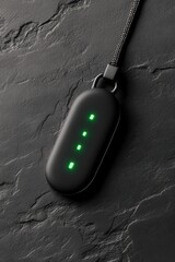 Black Pendant Device with Green Lights Displays Cybersecurity Awareness Concept on Dark Stone Surface Security System