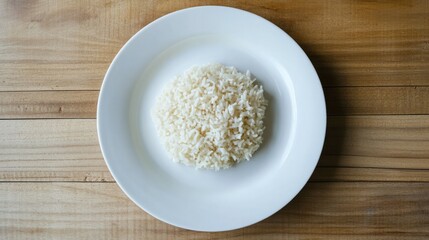Round white ceramic plate filled with finely shredded white cheese placed on a wooden surface with visible wood grain background