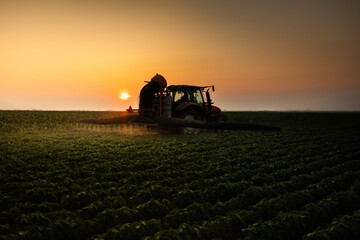 Fototapeta premium Tractor spraying soybean crops field
