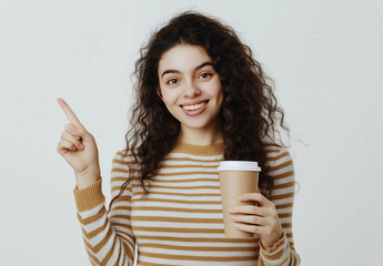 Happy Young Woman Holding and Pointing at Empty Coffee Cup – Studio Portrait on Light Blue Background, Confident and Stylish Pose, Ideal for Marketing, Advertising, and Lifestyle Concepts