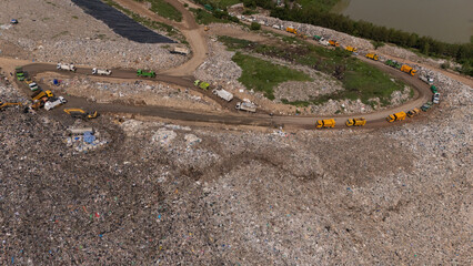 Trucks are collecting waste in large piles for disposal and recycling.	