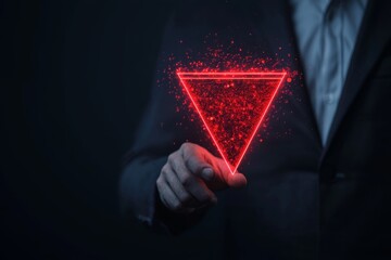 A businessperson in a suit interacts with a glowing red triangular hologram against a dark background.