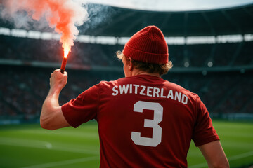 Swiss Fan in Red Beanie Holding Flare at Stadium

