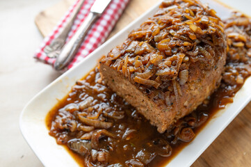 Delicious meatloaf with brown onion sauce fresh and homemade cooked