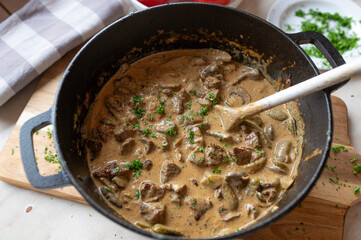 Beef goulash stroganoff style with delicious creamy mushroom, pickle sauce in a pot