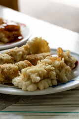 A crispy Taiwanese shrimp roll served hot and golden from the fryer. The roll is packed with minced shrimp, pork, and crunchy vegetables, all wrapped in tofu skin and deep-fried to perfection. Often
