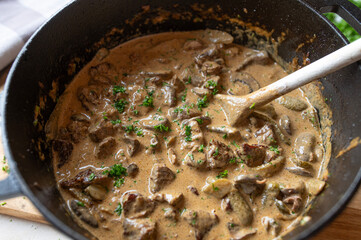 Beef goulash stroganoff style with delicious creamy mushroom, pickle sauce in a pot