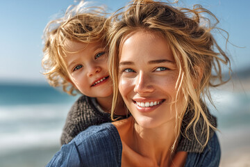 Portrait of a happy woman carrying her toddler on her shoulders, laughing and smiling at the beach in summer.