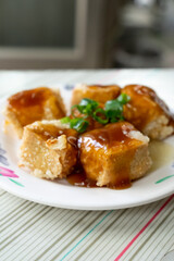 Taiwanese stinky tofu, deep-fried to a golden crisp on the outside while remaining soft inside, served with pickled cabbage and a spicy garlic sauce. This pungent yet beloved street food dish