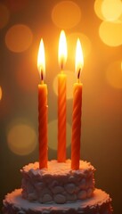Three Birthday Candles on Delicious Cake with Bokeh Lights