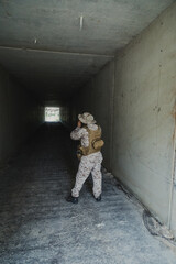 Fototapeta premium Soldier With A Camera Shooting Photos At The End Of The Tunnel