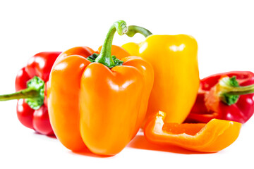 Mix of colorful whole and sliced ​​bell peppers. Isolated on white background.