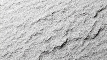 Close-up of a textured gray rock surface with natural patterns and shadows.