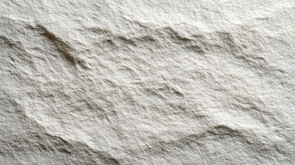 Close-up of a textured white stone surface with natural patterns and variations.