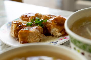 Taiwanese stinky tofu, deep-fried to a golden crisp on the outside while remaining soft inside, served with pickled cabbage and a spicy garlic sauce. This pungent yet beloved street food dish