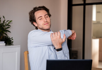 Executive doing stretches to prevent back pain at work