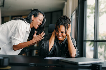 Boss shouting at frustrated worker, bullying and emotional abuse at work. Stressful work environment