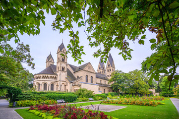 Beautiful view of Basilika Sankt Kastor in Koblenz surrounded by lush gardens and trees