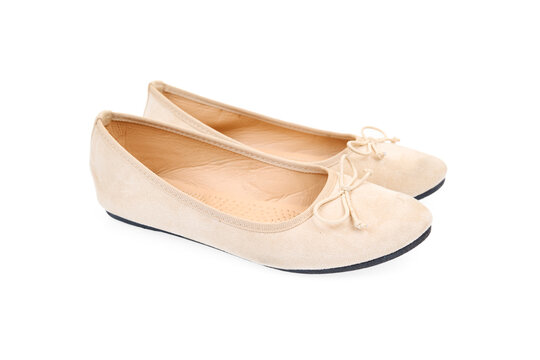 Pair of beige flat shoes isolated on white background. Elegant ballet flats.