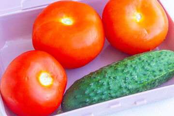 Cucumbers and tomatoes in a container, vegetables for salad, Healthy eating, food