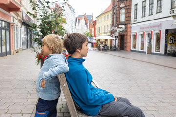 Family with children and pet dog, kids and adults visiting Flensburg, small town in Germany near Denmark during summer