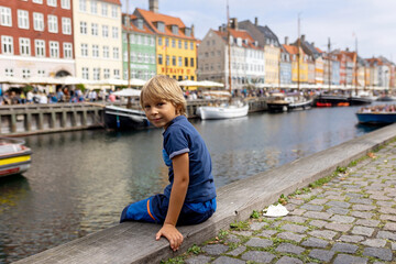 Family with children and pet dog, kids and adults visiting Coppenhagen , capital city of Denmarn during summer