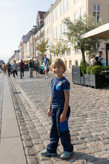 Family with children and pet dog, kids and adults visiting Coppenhagen , capital city of Denmarn during summer