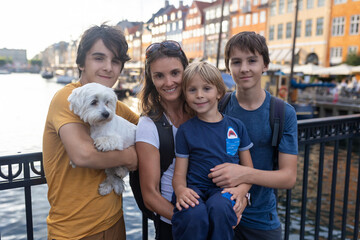Family with children and pet dog, kids and adults visiting Coppenhagen , capital city of Denmarn during summer