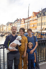Family with children and pet dog, kids and adults visiting Coppenhagen , capital city of Denmarn during summer