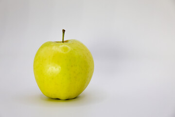 green apple on white background with reflection