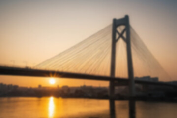 Fototapeta premium blurry photo of bridge in the afternoon showing beautiful sunset radiating from the corner of the bridge