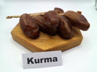 Date palm fruit on serving board. This is the edible, sweet fruit produced by the date palm tree