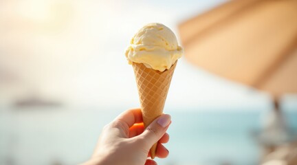 summer holliday beach. A person holding a cone of yellow ice cream against a sunny beach background, evoking a sense of summer and relaxation.