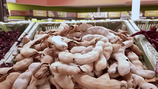 Medium shot of tamarind on a stand in a shop, indoor, handheld shot
