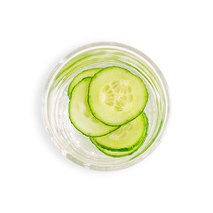 Top view of drinking glass with fresh healthy detox water drink infused with juicy refreshing cucumber vegetable circle slices isolated on white background used as cold antioxidant summer beverage