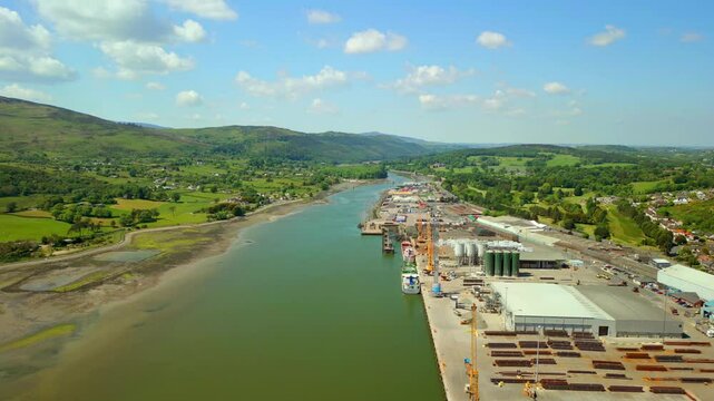 Reversing aerial video of the Newry River and surrounding industry in Warrenpoint, County Down, Northern Ireland, UK on a bright and sunny day. Filmed in 4K, 60FPS and with Rec709 color.
