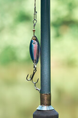 Close-up of fishing rod and spinners for fishing. Spinning rods for sport fishing. Vertical photo