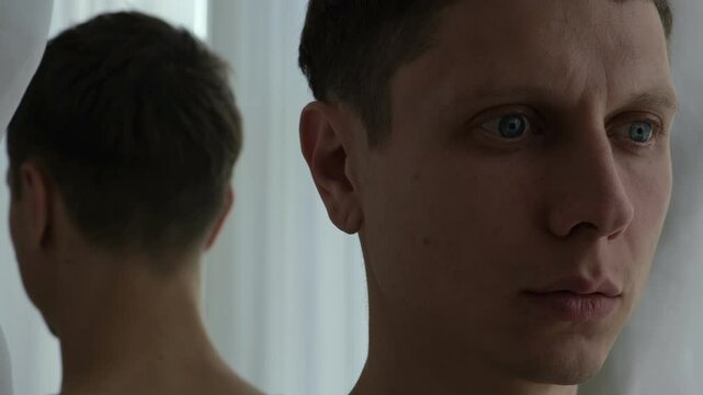 Man turns back to mirror, avoiding his own reflection. Symbolic struggle with inner truth, denial, and emotional conflict.