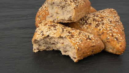 Triangular bun closeup. Wheat bread with sesame and flax seeds, healthy whole grain bakery