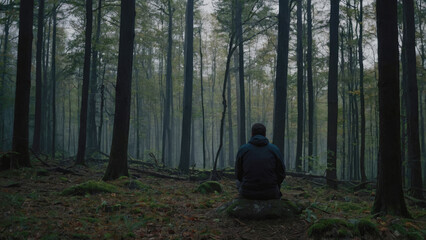 man in a dark gloomy forest