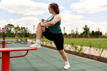 Young woman enjoying outdoor fitness session on a sunny day in the park