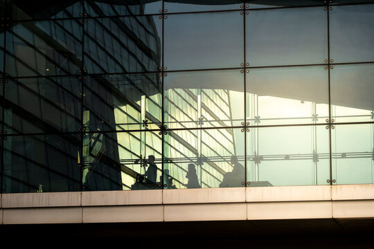 Glass facade with modern reflections and soft yellow light, Copenhagen, Denmark, abstract architectural detail with clean symmetry and minimalistic corporate design