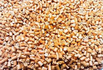 Brown polymer granules, brown masterbatch granules, cold cutting material type, isolated on white background for product catalog design of plastic manufacturing industry company profile	