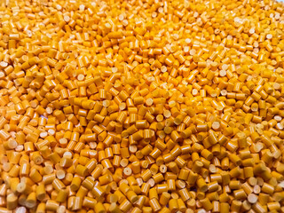 Orange polymer granules, orange masterbatch granules, cold cutting material type, isolated on white background for product catalog design of plastic manufacturing industry company profile	