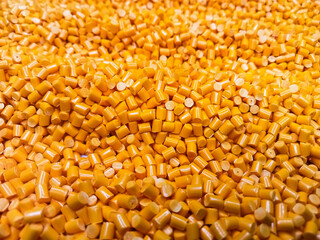 Orange polymer granules, orange masterbatch granules, cold cutting material type, isolated on white background for product catalog design of plastic manufacturing industry company profile	