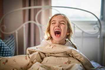 Night terrors of the child. Fear of the dark. The child girl on the bed at night.