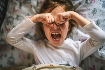 Night terrors of the child. Fear of the dark. The child girl on the bed at night.