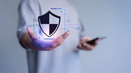 Person holds a digital shield icon, symbolizing cybersecurity, mobile data protection, and modern digital privacy solutions. Certified guarantee approval or secure access system concept.