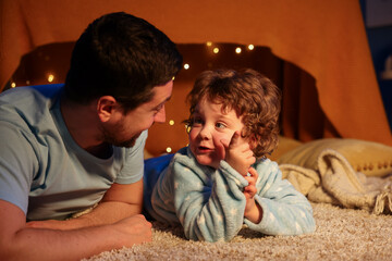Father and his son before bedtime on floor at home © New Africa