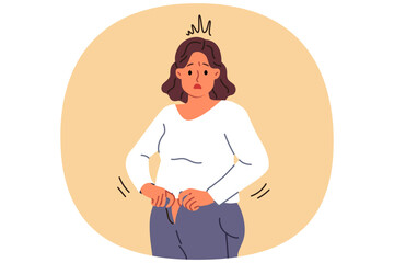Overweight woman cannot fit into old jeans due to excess weight caused by overeating and sedentary lifestyle. Problem of excess weight surprises girl who needs to follow diet or exercise